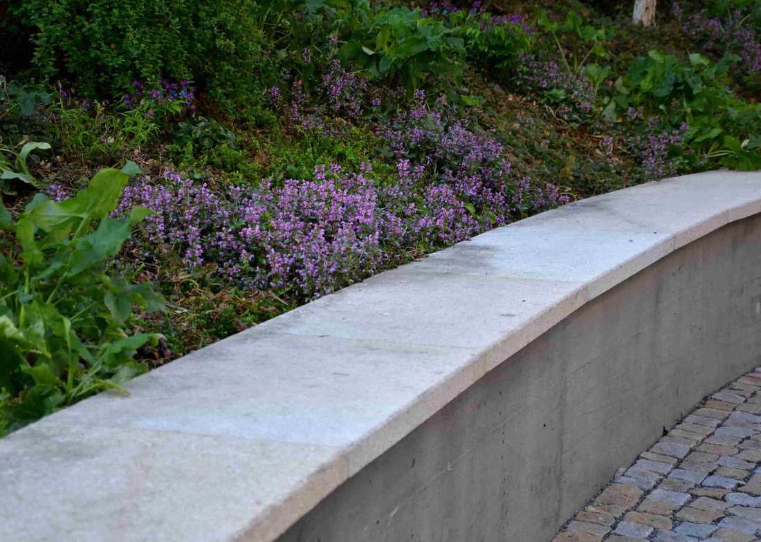 This retaining wall was installed in the city of Vancouver in a park. It does a perfect job of being seating option as well as keeping the greenery in place. 